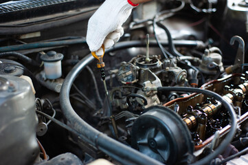 Fototapeta na wymiar A mechanic checks the car and engine oil.