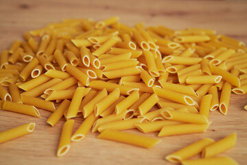 Detail of pasta penne on a kitchen counter