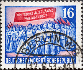 GERMANY, DDR - CIRCA 1953 : a postage stamp from Germany, GDR showing a march. On the 70th...