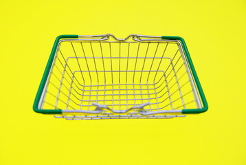 Small grocery metal supermarket shopping basket.Retail consumer purchases online. Delivery of goods to your home.