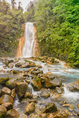 Blue water flowing through Gemelas waterfalls in Bajos del Toro, Costa Rica