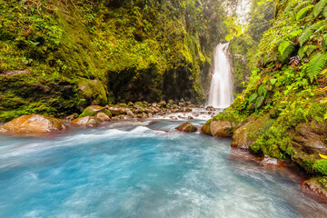 Blue water flowing through Gemelas waterfalls in Bajos del Toro, Costa Rica