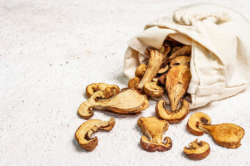 Forest dried edible mushrooms in a linen sack