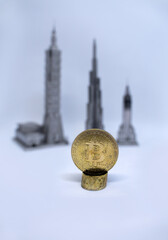 Electronic currency golden bitcoin against the background of which there are famous skyscrapers of the world