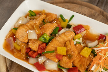 Salmon Sweet and Sour Stir Fried on wooden background ready to eat