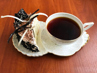 White cup with saucer and dessert.