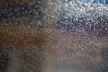 Blurred background with raindrops and lights.