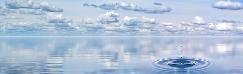 splash on the water that was formed from a drop falling against the background of a panorama of...