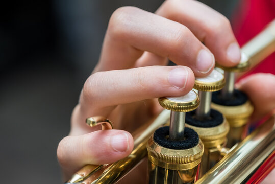 Close up of a child playing a trumpet 