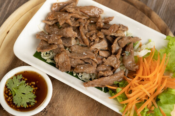 Well done Roast slice beef on the white plate wooden background ready to eat