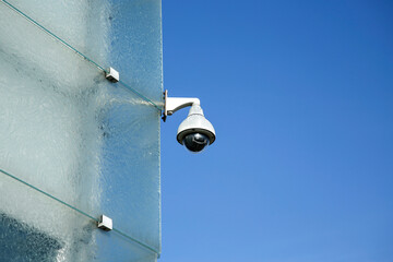 security CCTV camera on modern glass building