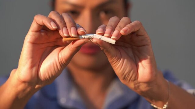 Close-up photo of a woman destroying cigarettes, World No Tobacco Day, May 31, Stop smoking.