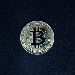Gold macro bitcoin on a black space background with the texture of stars and galaxies. Electronic...