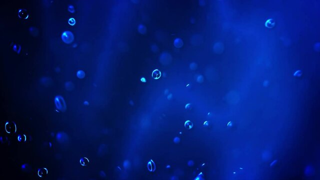 Motion of air bubbles up on the surface deep Underwater Bottom. Epic and mystical view from the blue ocean and sea floor. 