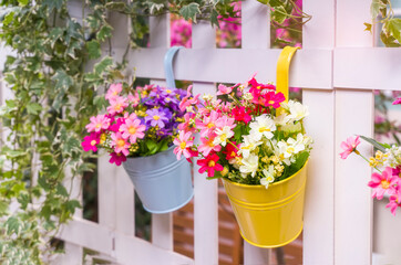 Fototapeta na wymiar Hanging Flower Pots with fence