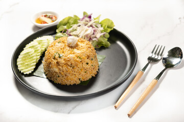 Crab Meat Fried Rice with folk and spoon on marble background ready to eat