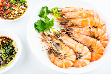 A plate of boiled black tiger prawns and seasoning sauce