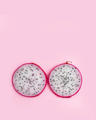 Red and pink dragon fruit slice with red and white flesh. The pitahaya fruit is low in calories, rich in essential vitamins and minerals, and contains dietary fiber.