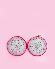 Fototapeta premium Red and pink dragon fruit slice with red and white flesh. The pitahaya fruit is low in calories, rich in essential vitamins and minerals, and contains dietary fiber.