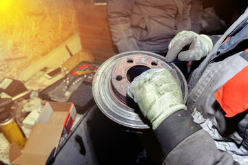 replacing the brake disc of a car in the garage
