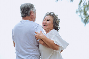 Happy asian senior retired couple, relax smiling elder man and woman enjoying with retired vacation at sea beach outdoor. Health care, Family outdoor lifestyle