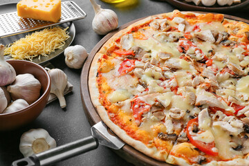 Board with tasty pizza on dark background