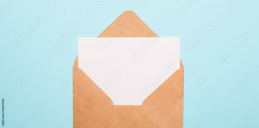 Poster on a light blue background, an sheet of paper with a place to insert text in a craft envelope. copy 