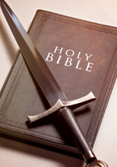 Bible and Sword on a Bright White Background