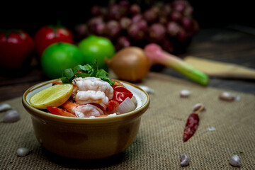 Low light photography spicy Thai food curry called Tom yum kung