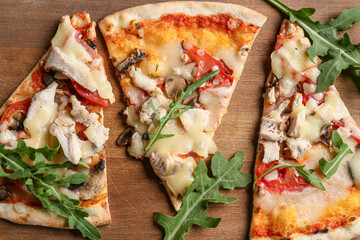 Slices of tasty pizza on wooden background