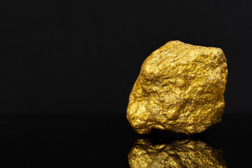 Investment sources on stock markets and financial concept: On right frame a single real raw gold...