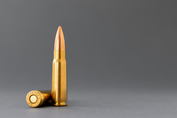 Two bullets on gray background. Cartridges 7.62 caliber for Kalashnikov assault rifle closeup with copy space