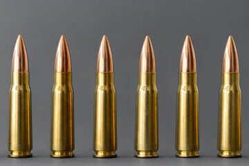 Bullets on gray background. Cartridges 7.62 caliber for Kalashnikov assault rifle closeup