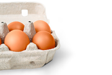 Brown eggs in a cardboard box. Isolated on a white background with a shadow.