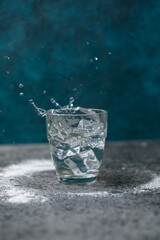 water splash in glass on blue
