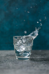 water splash in glass on blue