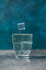water splash in glass on blue