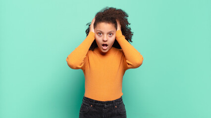 looking unpleasantly shocked, scared or worried, mouth wide open and covering both ears with hands
