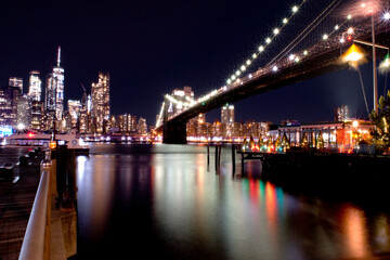 New York East River lights reflection under Manhattan Bridge by night