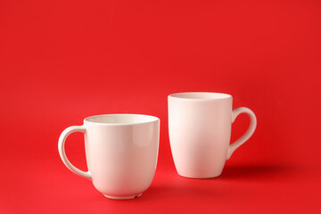 Empty cups on color background
