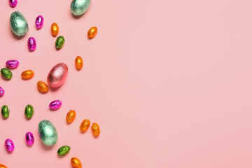 Sweet chocolate eggs on color background