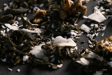 the dry tea with coconut on a black background