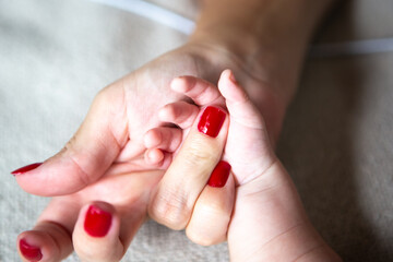 Close up of mother and child hands, love and security, mothers day