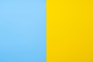 Fototapeta premium Yellow-blue background bisected vertically. Blue and yellow sheet of paper