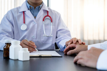 The doctor or pharmacist is discussing and encouraging the results of the treatment. With the patients who were examined, counseling ideas and treatment guidelines