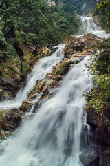 The stream of water between the rocks in the mountains Sri Lanka. Long exposure.