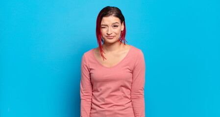  looking happy and friendly, smiling and winking an eye at you with a positive attitude