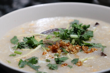 Rice porridge with mince pork and vegetables mixing with the egg