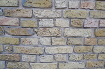 Peeled old brick wall. Brick yellow background.