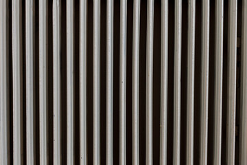 Old white heater creates striped pattern